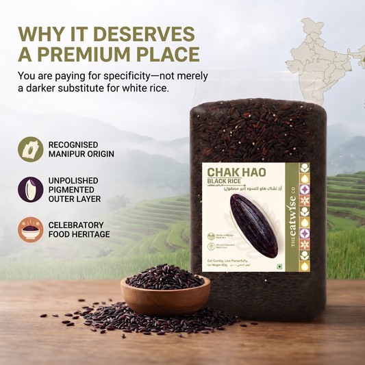 A jar of Chak Hao Black Rice displayed on a wooden surface with a small bowl of loose rice in front. The background shows green rice terraces and includes marketing text and icons about Manipur origin, unpolished outer layer, and food heritage.